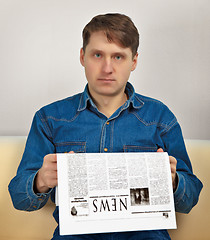 Image showing Man reads newspaper