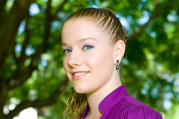Image showing Attractive Young Woman Head Shot Outside Trees