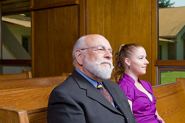 Image showing Senior Caucasian Man and Young Woman Sitting in Church Pew 