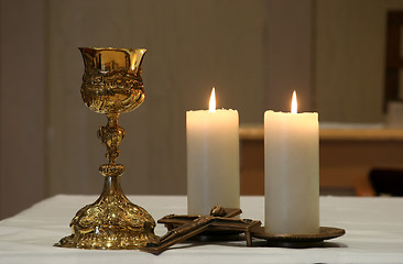 Image showing Golden chalice and two burning candles