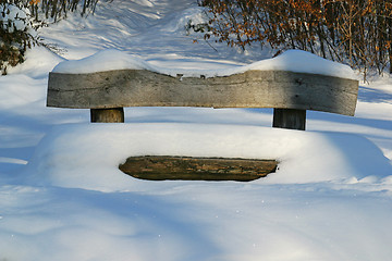 Image showing Wooden bench covered with snow