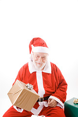 Image showing Smiling Santa Holding Wrapped Package Isolated