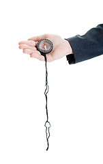 Image showing Caucasian Woman's Hand Holding Compass String, Isolated White Ba