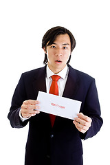 Image showing Shocked Asian Man Holding Foreclosure Notice Isolated on White