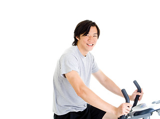 Image showing Smiling Asian Man on Exercise Bike in Work Out Clothing