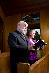 Image showing Senior Man Young Woman Church Singing Hymnals