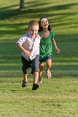 Image showing Two Young Children Running and Playing