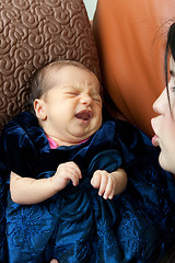 Image showing Mother Comforts a Crying Newborn Baby