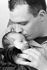 Image showing Happy Daddy Kissing His Baby Daughter