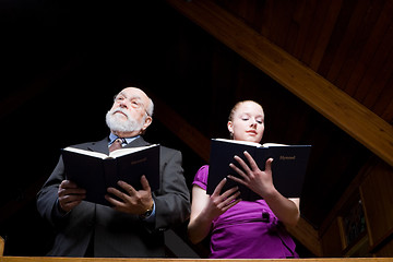 Image showing Senior Caucasian Man Young Woman Standing Singing Holding Hymnal