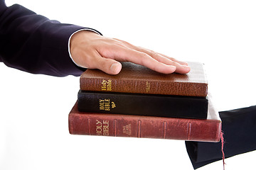 Image showing Man's Hand Stack of Bibles, Isolated Background