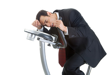 Image showing Exhausted Businessman Riding Exercise Bike Isolated White Backgr