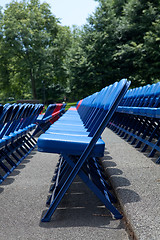 Image showing XXXL Rows of Blue Red Metal Folding Chairs Outside