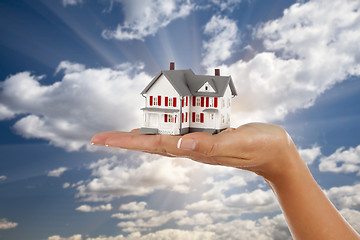 Image showing Model House in Female Hand on Sky Background