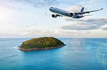 Image showing Passenger plane over tropical island