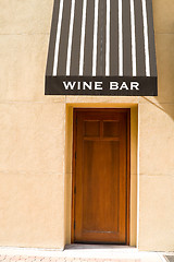 Image showing Entrance to a Wine Bar, Awning, Wood, Stucco