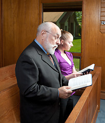 Image showing Older Man Young Woman Standing in Church Singing Holding Hymnals