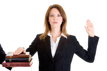 Image showing Caucasian Woman Swearing on a Stack of Bibles White Background