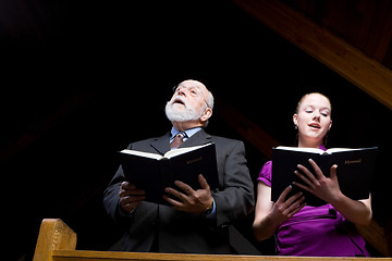 Image showing Senior White Man Young Woman Singing in Church Holding Hymnals