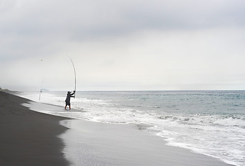 Image showing Fisherman on the ocean beach