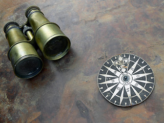 Image showing Old binoculars and compass rose