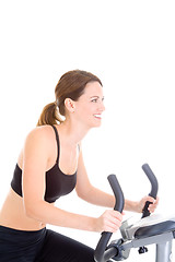 Image showing Smiling Caucasian Woman Riding Exercise Bike White Background