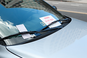 Image showing Parking Ticket Under Windshield Wiper On Car, Warning Sign
