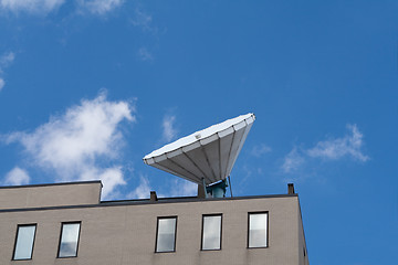 Image showing Large Satellite Dish on Roof, Blue Sky Background