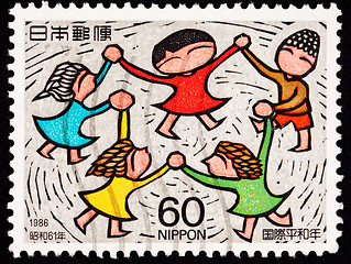 Image showing Canceled Japanese Postage Stamp Multicultural Children Holding H