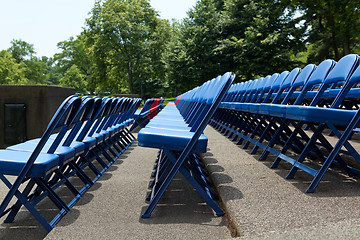 Image showing XXXL Rows of Blue Red Metal Folding Chairs Outside