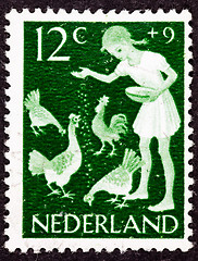 Image showing Canceled Dutch Netherlands Postage Stamp Farm Girl Feeding Chick