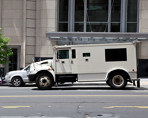 Image showing Side View Armoured Armored Car Parked on Street Outside Building