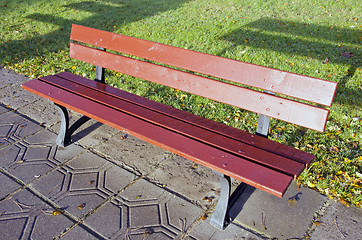 Image showing Lonely empty bench in the park. Object shadow.