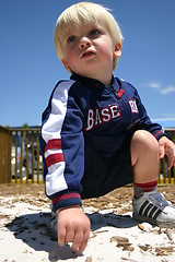 Image showing Blonde boy playing in sandy playground