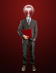 Image showing male in suit with lamp and laptop in his hands