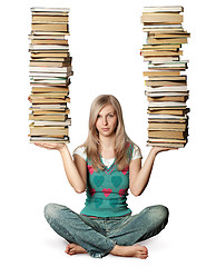 Image showing woman in lotus pose with many books in her hands