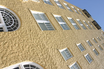 Image showing Yellow stucco building angled perspective