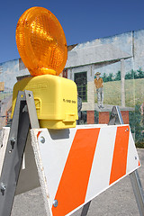 Image showing Traffic barricade set against a painted wall