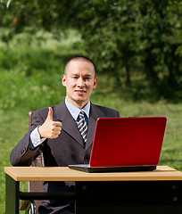 Image showing man with laptop working outdoors