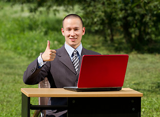 Image showing man with laptop working outdoors