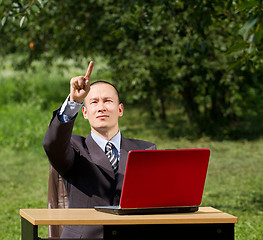 Image showing man with laptop working outdoors