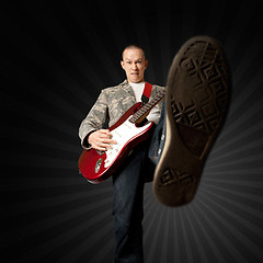 Image showing rocker with guitar and foot