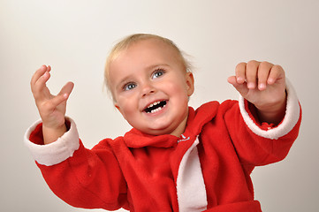 Image showing happy Christmas baby with hands raised