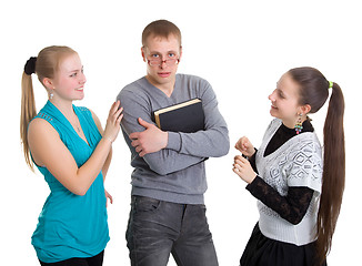 Image showing Two girls and a guy with glasses with a book