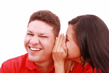 Image showing woman telling a man a secret - surprise and fun faces - over a w