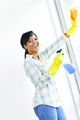 Image showing Smiling woman cleaning windows