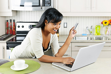 Image showing Woman shopping online at home