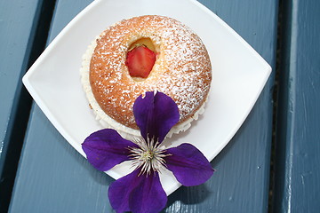 Image showing Muffins together with clematis-flower
