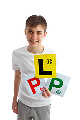 Image showing Teen holding magnetic driving licence plates for car