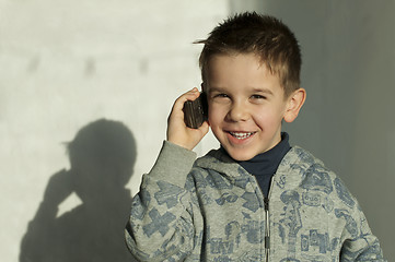 Image showing Child talking by mobile phone